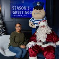 Young woman sits next to Santa and Louie